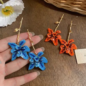 Elegant statement long floral earrings with branch design in blue and orange colors