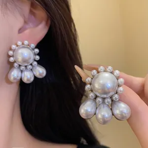 Close-up of vintage French court style pearl earrings with elegant teardrop pendants