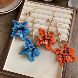 Exaggerated long floral branch earrings in blue and orange colors