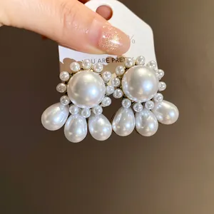 Detailed macro view of French retro pearl earrings with elegant teardrop pendants
