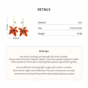 Detail view of orange flower drop earrings with dimensions and 925 silver needle info