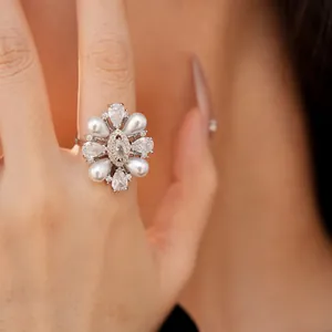 Primo piano di un anello placcato oro 14k con perle a goccia e zirconi trasparenti
