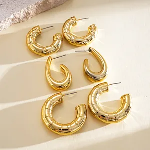 Detailed macro shot of a six-piece set featuring gold geometric C-shaped and teardrop earrings.