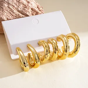 Detailed view of six chunky gold-plated C-shaped and water-drop geometric earrings