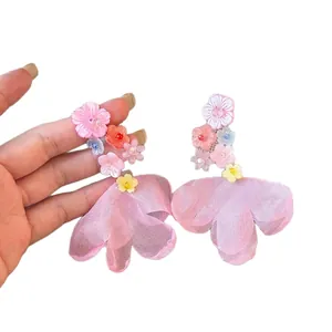 Elegant resin flower stud earrings with pink chiffon petal tassels for seaside vacation.