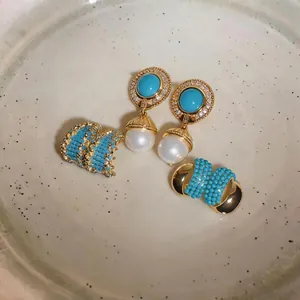 Vintage gold jewelry set featuring turquoise bead earrings and elegant white pearl drops