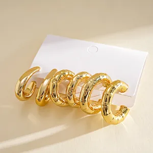 Set of 6 chunky gold-plated C-shaped hoop earrings with geometric teardrop designs.