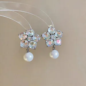Elegant S925 silver needle flower earrings featuring iridescent crystals and white pearl drop
