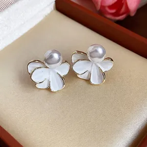 Elegant 18k gold plated white enamel flower stud earrings with center pearl detail
