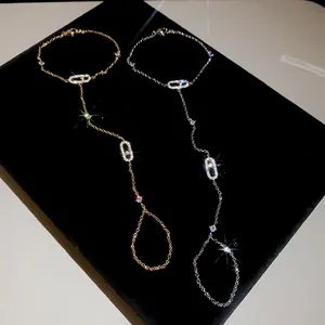 Close-up of sparkling zircon oval link slave bracelet in gold and silver finish