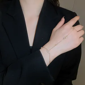 Elegant hand chain bracelet with sparkling zircon oval details on a model's hand