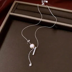 Elegant silver-toned necklace featuring a pearl and textured metal bar pendant