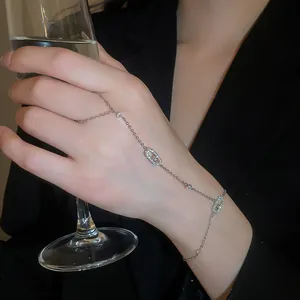 Close-up of a sparkling zirconia oval finger bracelet hand chain in silver finish