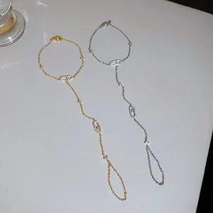 Elegant gold and silver zircon slave bracelets with oval motifs on white background