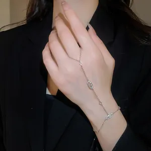 Elegant silver oval zircon hand chain bracelet featuring unique link design on model