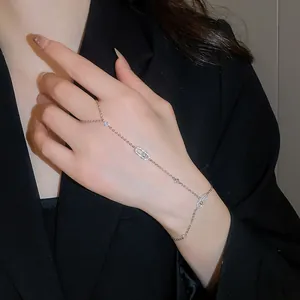 Close-up of a sparkling zircon oval hand harness bracelet worn on model's hand