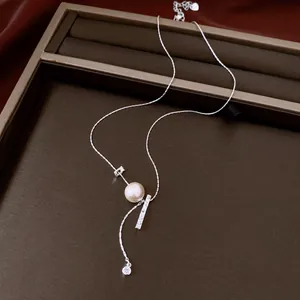 Exquisite detail of silver clavicle necklace featuring a pearl and textured bar pendant