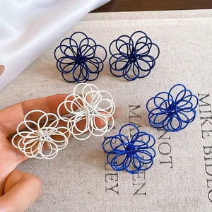 Minimalist painted wire-wound flower stud earrings available in blue and white colors
