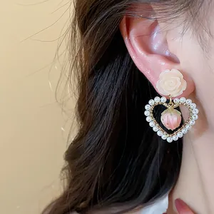 Close-up detail showing the craftsmanship of 14k gold plated heart earring with pearls and strawberry