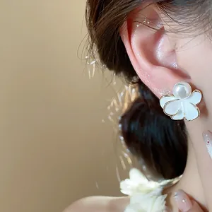 Elegant 18k gold plated white enamel flower and pearl stud earrings detail view