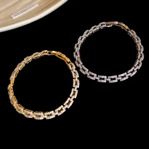 Detailed view of 14k gold and silver plated bracelets featuring zircon-studded links