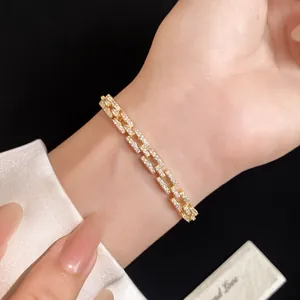 Close-up of 14k gold plated link bracelet with shimmering cubic zirconia stones.