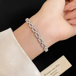 Close-up of 14k gold plated chain link bracelet with sparkling cubic zirconia stones.