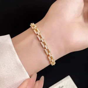 Elegant 14k gold-plated buckle bracelet with pavé zircon links worn on a female wrist
