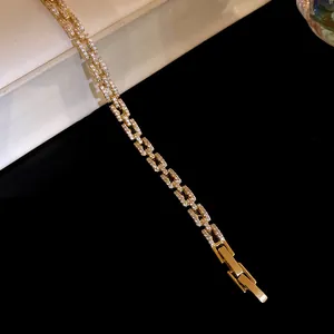 Detailed macro view of the luxury 14k gold plated bracelet with sparkling zircon links.
