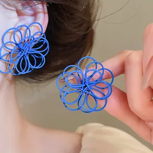Detailed view of matte blue wire-wrapped flower earrings showing unique layered texture