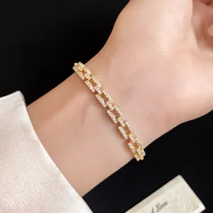 Close-up detail of 14k gold plated bracelet with pave-set cubic zirconia on wrist.