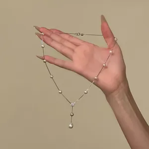 Elegant silver pearl necklace with zircon flower pendant detail