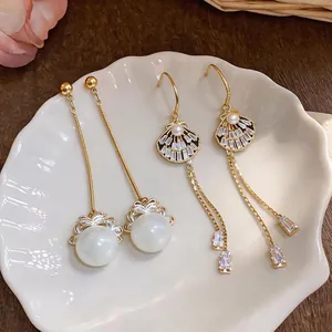 Elegant long tassel earrings featuring pearls and crystals in a premium gold finish