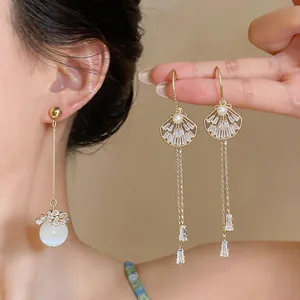 Elegant gold tassel drop earrings with shell design and pearl details for women