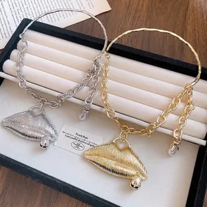 Statement textured lip pendant necklace with rhinestones in gold and silver finish