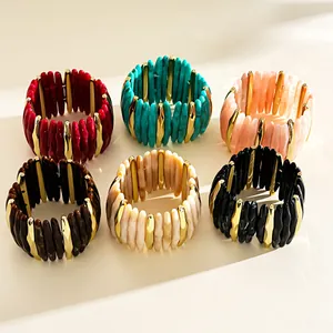Detail view of colorful acrylic marbled geometric stretch bracelets with gold accents