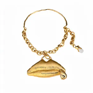 Dramatic gold lips pendant necklace with rhinestone accents and pearl drop charm