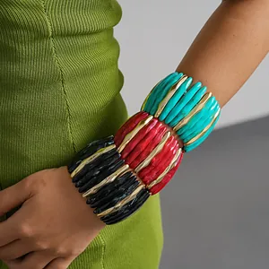 Detail view of colorful chunky acrylic elastic bracelets with marble texture and gold accents