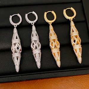 Detailed macro view of hollow rhombus drop earrings with pavé cubic zirconia inlay