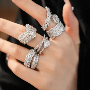 Detailed view of several exquisite silver zircon rings with V-shape and floral designs