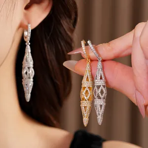 Close-up detail of elegant hollow rhombus drop earrings featuring intricate pavé crystals