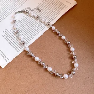 Detailed macro view of French style pearl and crystal beaded necklace on vintage paper