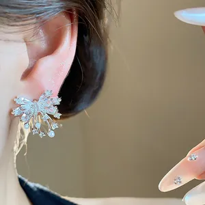 Close-up of elegant Korean style zircon bowknot stud earrings with pearls on ear