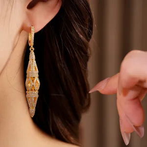 Close-up detail of exquisite gold hollowed-out rhombus pavé drop earrings for women