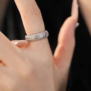 Detailed close-up of a silver band ring with square-cut cubic zirconia crystals