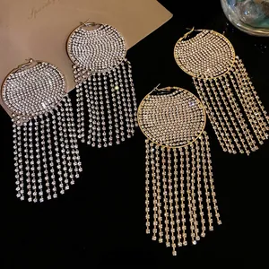 Elegant silver needle hoop earrings with rhinestone circle and long tassels.
