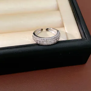Detailed view of elegant silver-tone ring featuring square-cut cubic zirconia stones