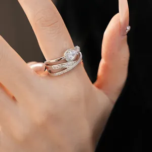 Macro detail view of a silver ring featuring a pear-cut zirconia and pavé stones