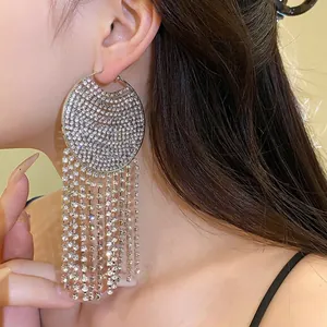 Silver needle rhinestone hoop earrings with long sparkling tassels worn by model