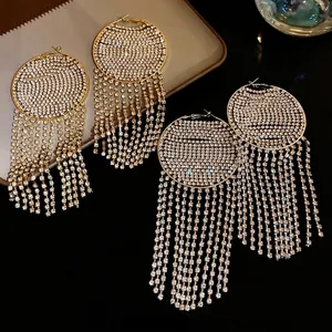 Luxury gold rhinestone hoop earrings with long shimmering crystal tassel fringe